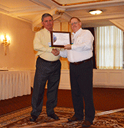 Bob Bodemuller of Ball Aerospace & Technology Corp. receives an award from Kevin Ward, Nadcap Management Council Chair