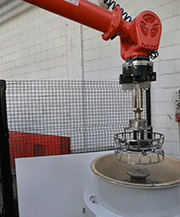 Side view of the operation to remove the frame from the vibratory finishing machine