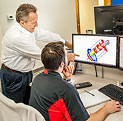 Head of Mechanical Engineering Gary Grossenbacher reviews a custom laser peening tool design with Mechanical Engineer Devin Hilty. LSP Technologies now develops specialized laser beam delivery tools for addressing large stationary components, complex geometries and hard-to-reach surfaces. 