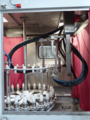 Inside view of a fully automated wet blasting “batch” machine for edge rounding of cutting tools