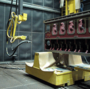 Fig. 3: Fully automated blast cleaning of large casted motor blocks