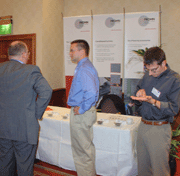 Peter Beckmerhagen (centre) of Frohn GmbH  in front of his booth