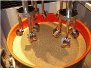 Photo 7: In drag-finishers, a carousel “drags” the work pieces like knee femorals through the grinding or polishing media in the processing bowl