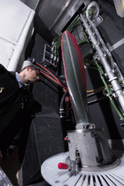 A propeller blade about to be processed in a Vapormatt Leopard automatic wet-blasting machine