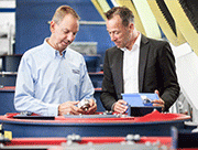 Michael Becker (left) inspects a customer’s workpiece