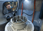 An aircraft wheel being processed insdie a Vapormatt PumaXL manual wet blasting machine