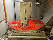 Vapormatt Cougar+ automatic wet blasting machine with an aerospace turbine blade loaded on its truntable - the fan has Almen Strips attached for measuring peening