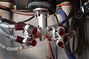 The blast guns of a Vapormatt Sabre robotic wet blasting machine configured for turbine blade cleaning and peening