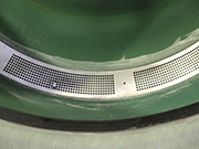 View of the dust extraction vent in a Rösler rotary vibrator. The vent is located at the bottom of the processing bowl.