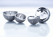 Acetabular cups before and after fine grinding and polishing: Surface roughness values of Ra ≤ 0.05 µm are consistently achieved without jeopardizing any dimensional tolerances