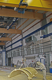 Open-space paint spraying area. In the background: Movable telescopic dryer in parked position.